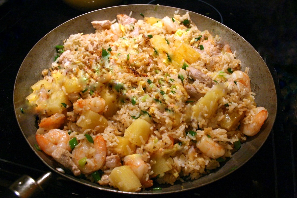Wok d’ananas au curry avec porc et crevettes, servi chaud dans une ambiance exotique