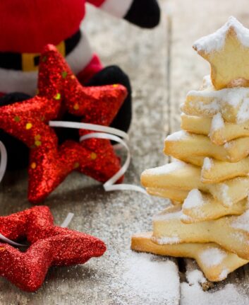Homemade gingerbread cookies christmas tree decorated icing on wooden background