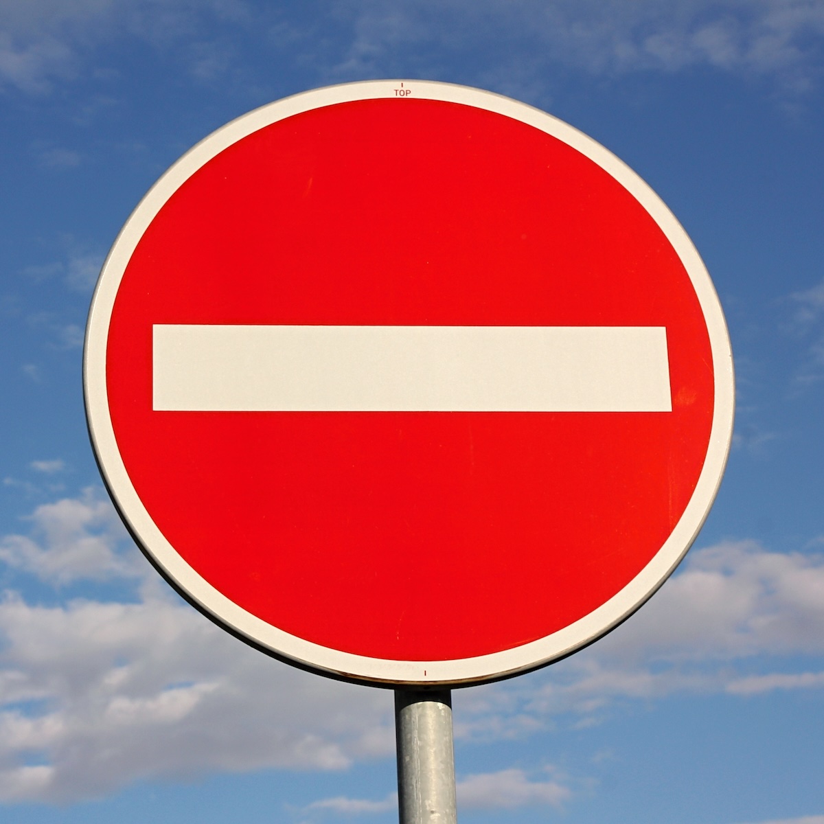 No entry for vehicles traffic sign against blue sky