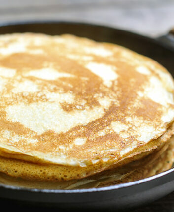 Stack of pancakes on a cast-iron frying pan. Rustic. Shallow DOF