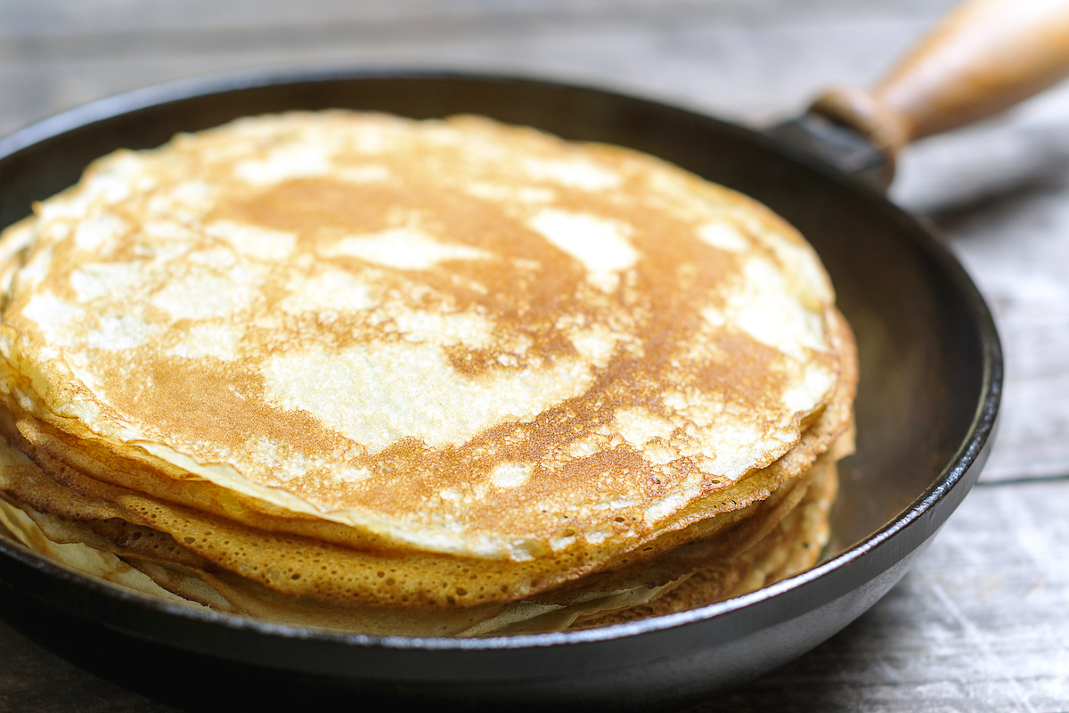 Stack of pancakes on a cast-iron frying pan. Rustic. Shallow DOF