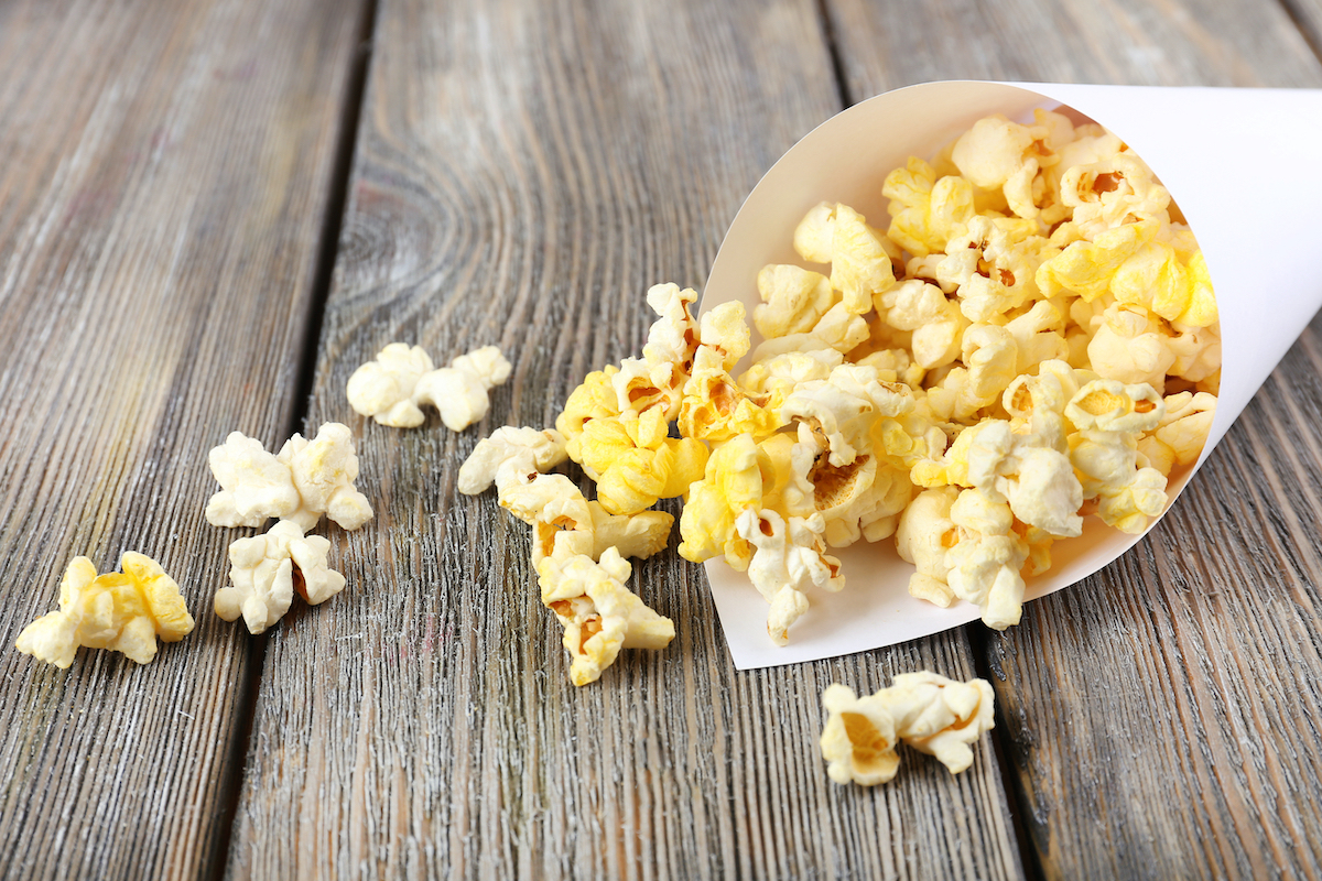 Popcorn on wooden table, close up