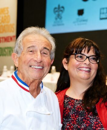 Michel Guérard en veste blanche et Anne Lataillade en veste rouge sourient lors d’un événement gastronomique