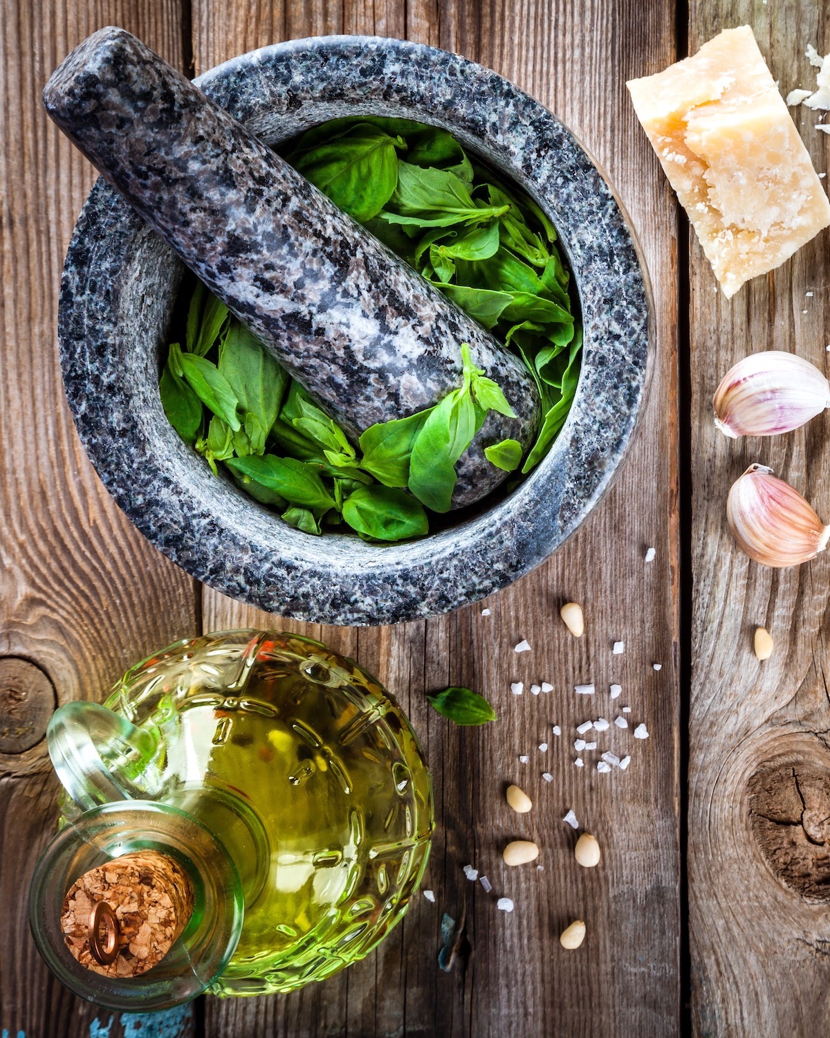 ingredients for homemade pesto: basil, parmesan, pine nuts, garlic, olive oil