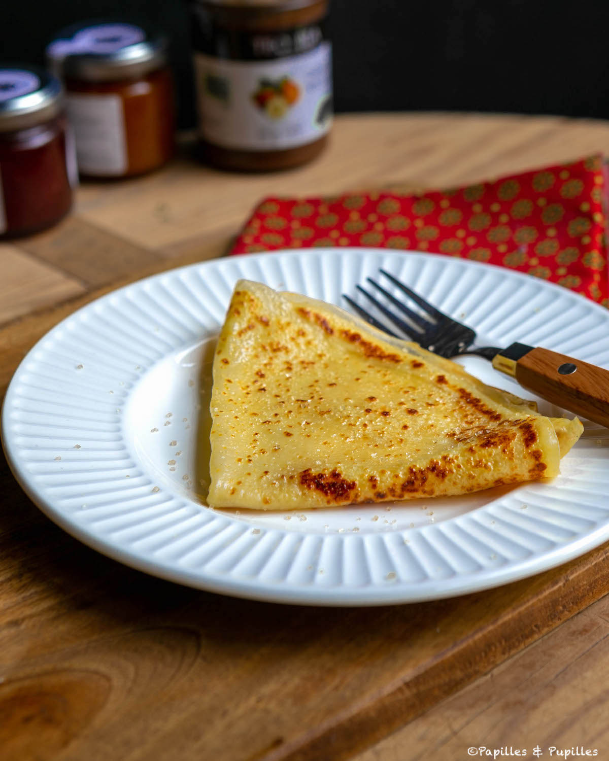 Crêpe facile et moelleuse, pliée en quatre dans une assiette