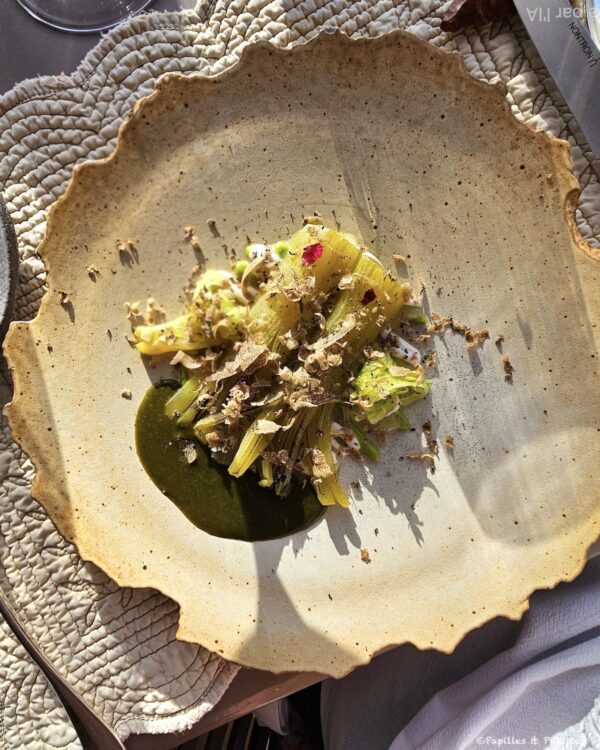 Celtuce servie avec une sauce verte et de la truffe fraîche râpée à table au restaurant Le 1862