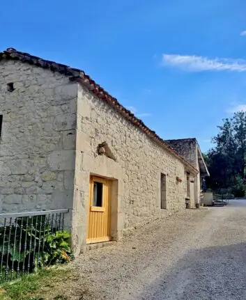 Entrée du gîte Les Fontanelles du Quercy Blanc avec bâtiments en pierre